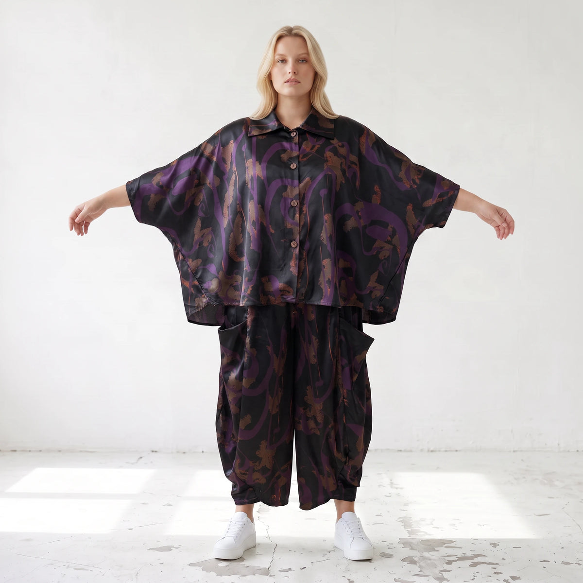 Ballonhose aus Satin in Schwarz/Violett/Braun mit abstraktem Printmuster und Elastikbund