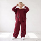 Oversized French Terry Hose in Schwarz mit Smileyprint gesmoktem Saum und weitem Bein