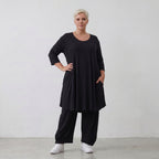 Fließendes Glockenshirt in tiefem Schwarz mit 3/4-Arm Rundhalsausschnitt und Nahttaschen